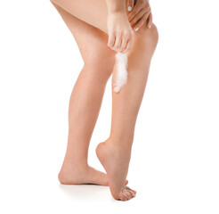 Legs of beautiful young woman with soft feather on white background. Epilation concept