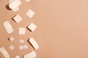 Many different medical plasters on color background