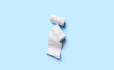 Medical elastic bandage rolls on color background