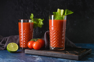 Glasses of bloody mary with celery and tomatoes on table - obrazy, fototapety, plakaty