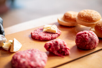 Male chef cook preparing homemade burger.