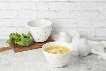 Bowl with delicious dumpling soup on table