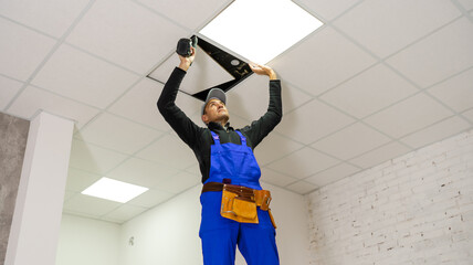 Ceiling installation with expert technicians In the room that is in the construction process.
