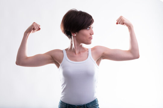 Fit young woman flexing her arms showing her biceps