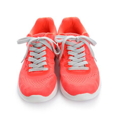 Pair of sportive shoes with tied laces on white background