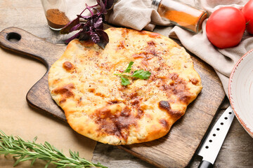 Board with tasty khachapuri on wooden background
