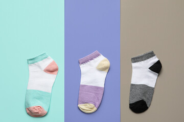 Different socks on color background