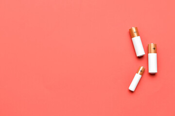 Alkaline batteries on red background, top view