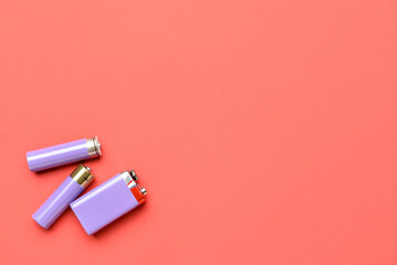 Alkaline batteries on red background, top view