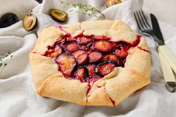 Tasty plum galette on table, closeup