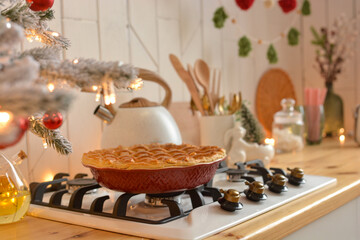 Christmas white kitchen in the Scandinavian style. Christmas decorations. Breakfast, Christmas traditions, pie, tree