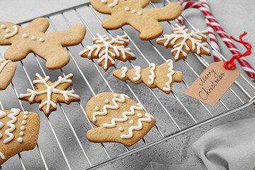 Stand with Christmas gingerbread cookies on light background