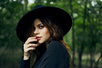 woman dressed as a witch in the forest Halloween fantasy ritual