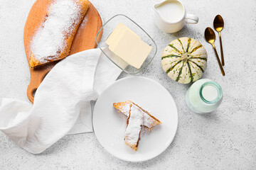Composition with tasty pumpkin strudel and milk on light background