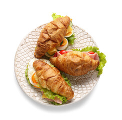 Plate with delicious croissant sandwiches on white background