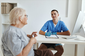 an elderly woman is examined by a doctor health care