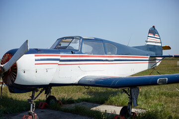 A sporty little plane stands at the airfield an airplane for extreme recreation and pleasure