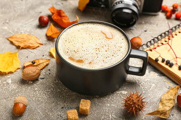 Autumn composition with cup of coffee on grey background