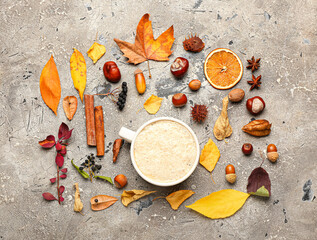 Autumn composition with cup of coffee on grey background