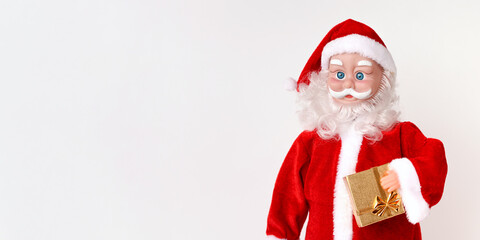 Santa Claus with gift on christmas time on white background. Front view. Banner. Copy space.