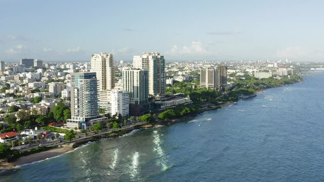 Seafront skyscrapers along Malecon in Santo Domingo. Aerial forward