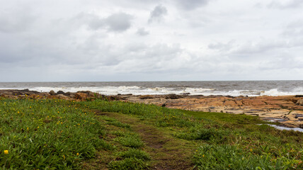 A view of the sea with a rocky embankment on the coastline of South Africa