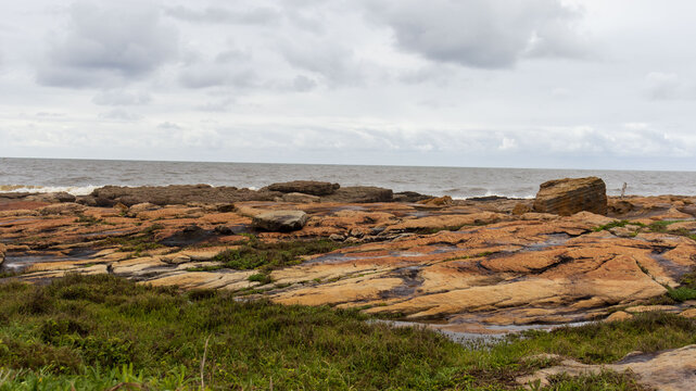A view of the sea with a rocky embankment on the coastline of South Africa