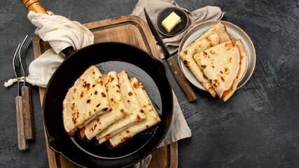 Crepes with sweet toppings on dark background.