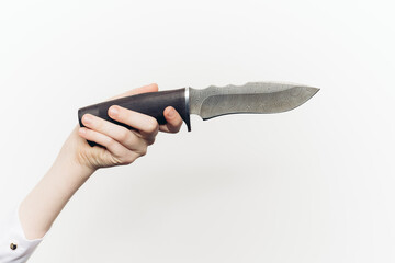 knife in hand close-up light background edged weapon