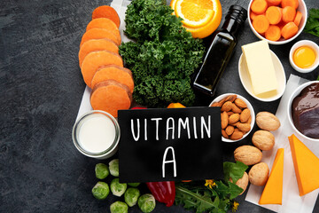 Foods high in vitamin A on dark background.