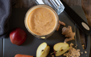 Immune system strengthening and anti-inflammatory smoothie with oat flakes, whey protein, ginger, turmeric, apple and carrots and olive oil