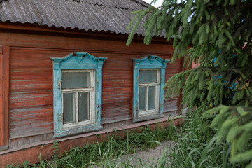 The beautiful old windows with beautifully designed platbands window on an old wooden house in the city of Tula