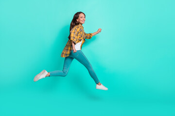 Fototapeta na wymiar Full size profile photo of mature sweet brunette lady run wear shirt jeans shoes isolated on turquoise background