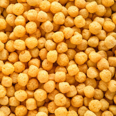 Orange puffy cheese balls, food background.