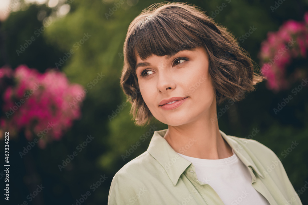 Poster Portrait of attractive dreamy brown-haired girl spending sunny day good mood at blooming garden outdoors