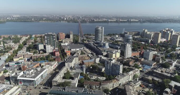 Aerial flight over the center of Dnipro city. A city on the dnieper river. Flying over the old city near the river. Eastern european city from the air.