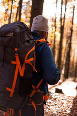 A man with a backpack travels through the forest, travel concept. 