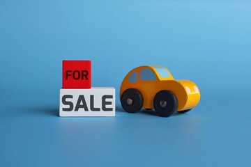 Business and finance concept. Wooden toy car and wooden cubes with text FOR SALE