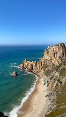 Obraz premium The coast with a rocky shore. Top view of the sea, mountains and beach.