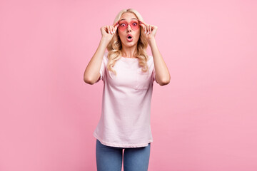 Obraz na płótnie Canvas Photo of impressed millennial blond lady wear spectacles t-shirt isolated on pink color background