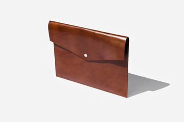 Folder from genuine leather handmade for papers and documents on a white isolated background.