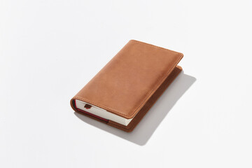 Notebook or diary for entries from genuine leather handmade on a white isolated background. Fashionable and stylish accessory for a businessman.