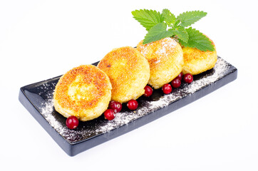 Sweet cottage cheese pancakes on plate, dairy products. Studio Photo.