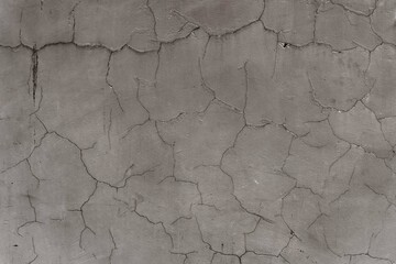 old cracked gray surface from an ancient wall - surface texture for a background symbol of desertification and dryness