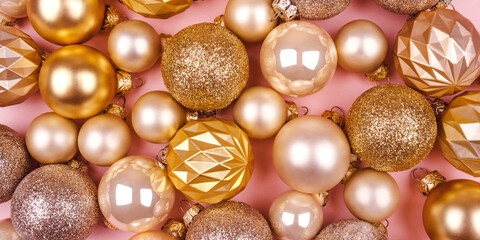 Festive pink background with gold and silver Christmas balls.