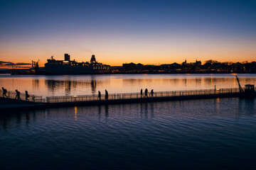 Scenic night view of Oslo fjord, big ship liner in the bay and city with lights