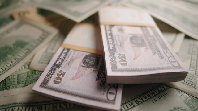American 100 and 50 dollar banknotes close up. Concept of saving money or monetary inflation and cash flow.