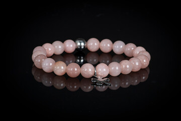 Fashion accessories. Jewelry on black reflective background. Gemstone bracelets. Natural stones beads. Handmade jewelry.