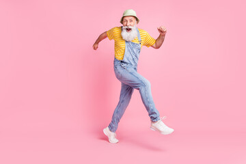 Full length body size view of attractive cheerful lucky man running fooling isolated over pink pastel color background