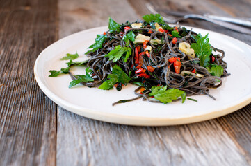 Black bean pasta with garlic, olive oil, bell peppers, and parsley alla aglio e olio